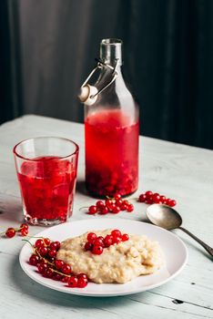 Simple and healthy breakfast with porridge and infused water with berries