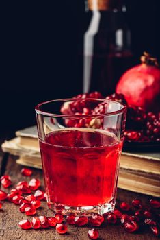 Drinking glass of pomegranate cocktail with fresh fruit