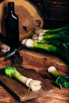 Fresh green leek on wooden cutting board