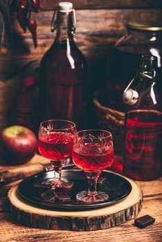 Homemade berry liqueur in rustic setting