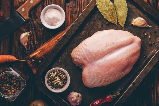 Raw chicken breast on baking sheet