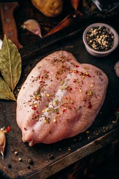 Seasoned chicken breast ready for roast in oven