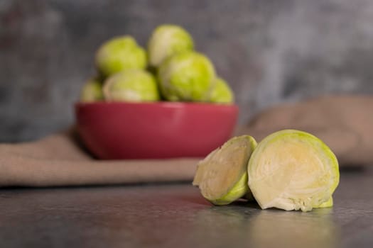 Fresh brussels sprouts served in bowl and with marbled gray background