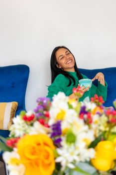 Happy beautiful young woman with her flower arrangement in your home
