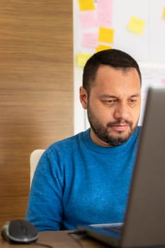 Young man working with his laptop