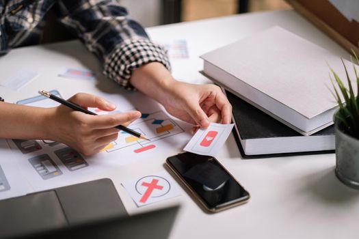 UI Designer drawing website UX layout app development. Graphic designer creative sketch planning application process. User experience concept.