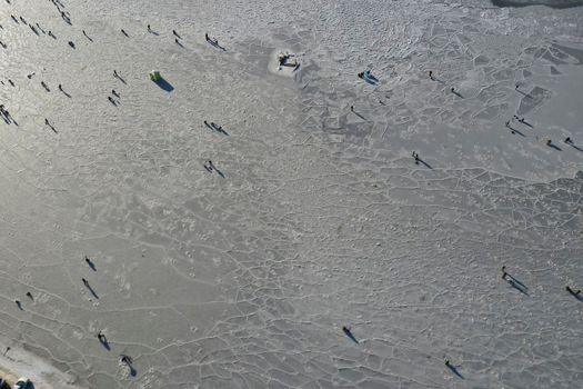 Aerial view of the Bay in the ice with fishermen on winter fishing. Vladivostok, Russia