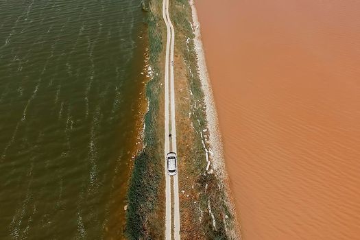 aerial view of lake Sasyk-Sevash and view of the road with a white car. Evpatoria, Crimea