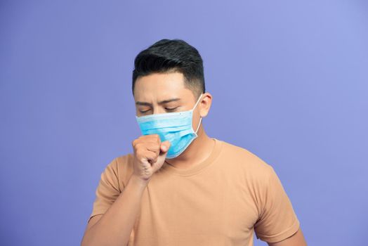 Asian man wearing a face mask with coughing