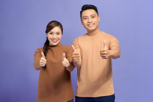 smiling couple showing thumbs up