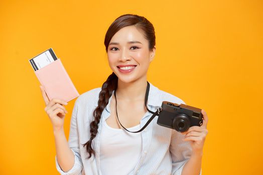 Portrait of young asian woman holding passport and smile. Happy people and travel concept.