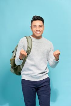 Happy successful student, business man winning, fists pumped celebrating success isolated blue background.