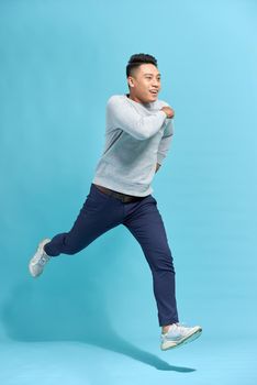 I will be in five minutes! Full length of handsome young man while running against white background