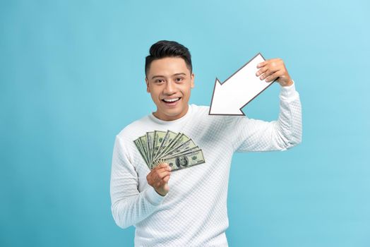 Man holding money and white arrow over blue background