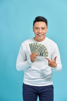 Man holding money and white arrow over blue background