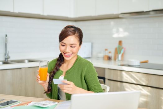 Young beautiful woman paying taxes with credit card
