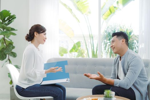 Female psychologist with client in office
