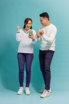 surprised Asian couple watching the smartphone