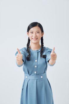 exited woman giving double thumb up studio isolated portrait