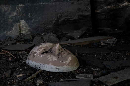 white ceramic mask abandoned in a factory that gives a feeling of abandonment