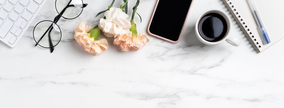 Mother's Day concept. Top view of greeting with carnation flower on mother's office table desk background.