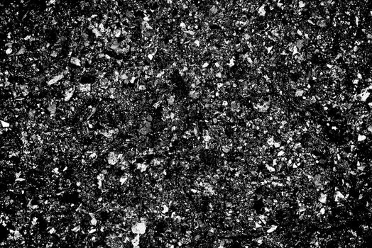 A high grain heavy texture photograph of black and white ash in a bbq