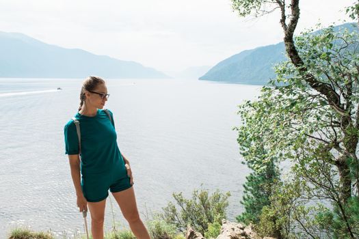 Woman on Teletskoye lake in Altai mountains, Siberia, Russia. Beauty summer day.