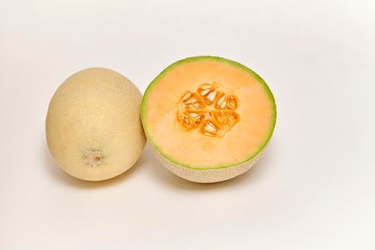 Whole and sliced Japanese melon, honey melon or Cantaloupe (Cucumis melo) on a white background