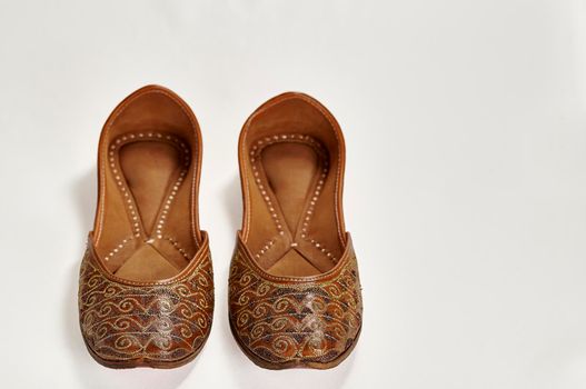 Traditional pure leather footwear (jutti) from India on a white background