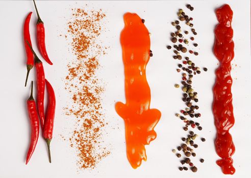 Chili peppers, spices and sauces on a white background. close-up. High quality photo