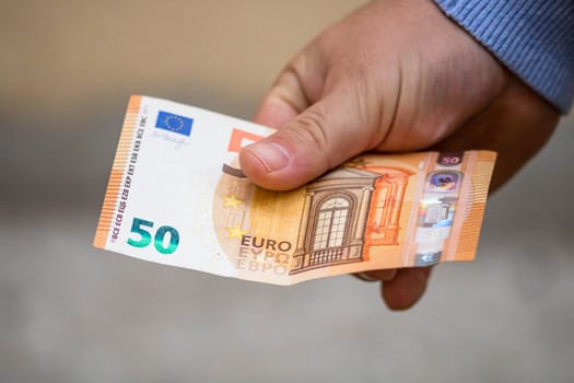 Selective focus on detail of EURO banknotes. Counting or giving EURO banknotes. World money concept, inflation and economy concept