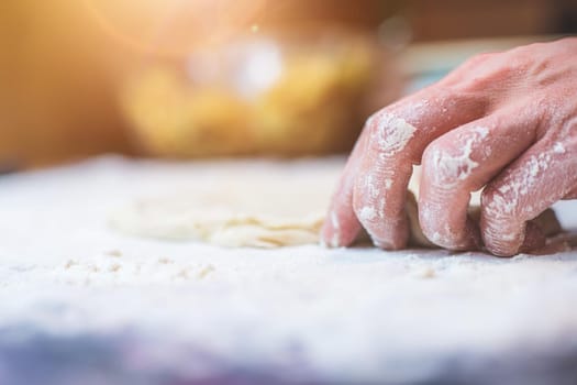 Close up of woman rolling traditional dough in the kitchen