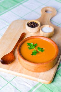 Pumpkin soup served on the table in bowl
