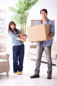 Young family moving in to new apartment after paying off mortgage