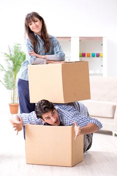 Young family moving in to new apartment after paying off mortgage