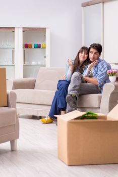 Young family moving in to new apartment after paying off mortgage