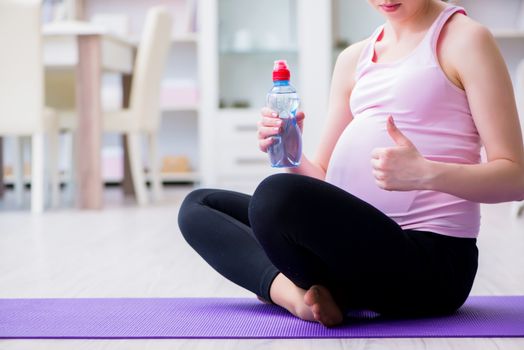 Pregnant woman exercising in anticipation of child birth