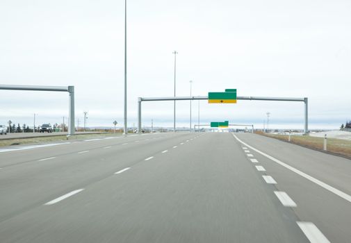 an empty stretch of highway with blank signs in canada