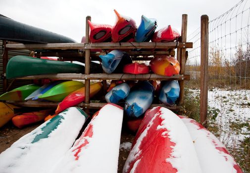 a group of kayaks or canoes put away for the winter 