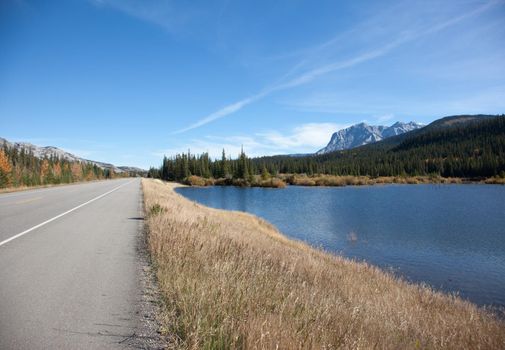 a view of the Canadian rocky mountains and a lake by the roadside in Jasper National Park, Alberta 