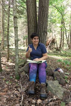 Hiker happy with their thumbs up grinning on an adventure