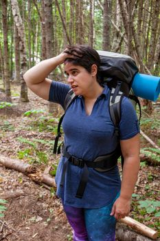  person looks very upset or stressed while lost in the woods 