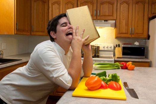  Person crying in the kitchen, sobbing into their cookbook with vegetables in the foreground