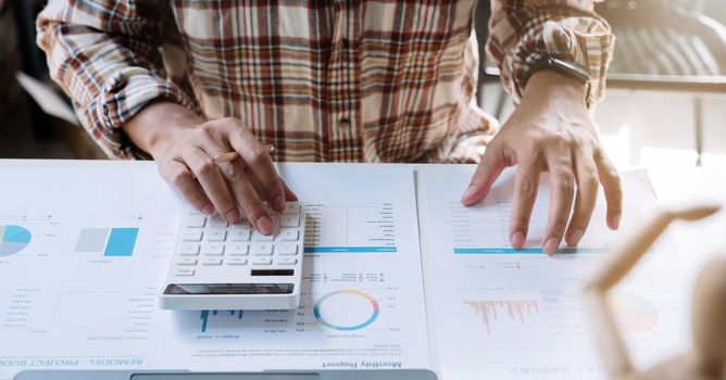 Close up business man working in finance and accounting Analyze financial budget work from home concept