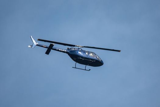 terni,italy april 30 2021:private half blue color flying helicopter