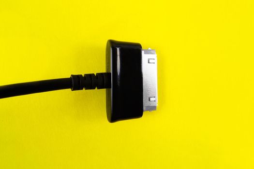 A black socet for tablet on a yellow background. Object.