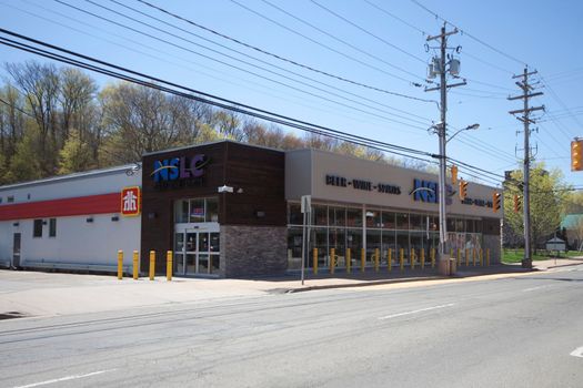 Kentville, Nova Scotia - May 7, 2013: Looking at the Nova Scotia Liquor Commission in Kentville, with other local shops nearby, at the intersection of Main and Aberdeen