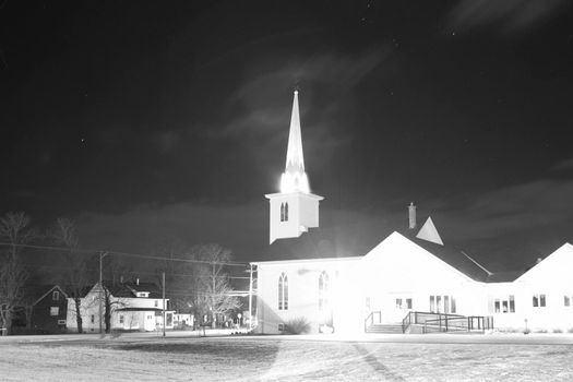 Port Williams, Nova Scotia: December 24, 2012: Stars light up over a midnight photo of the Port Williams United Baptist Church, a local landmark