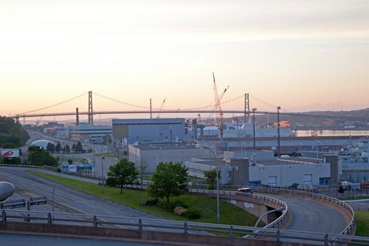 Halifax, Nova Scotia: July 7, 2011- Overlooking the naval dockyard with construction, the MacDonald bridge at sunset