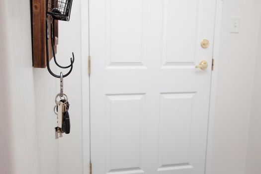  entryway of a home with front door, keys and shelf